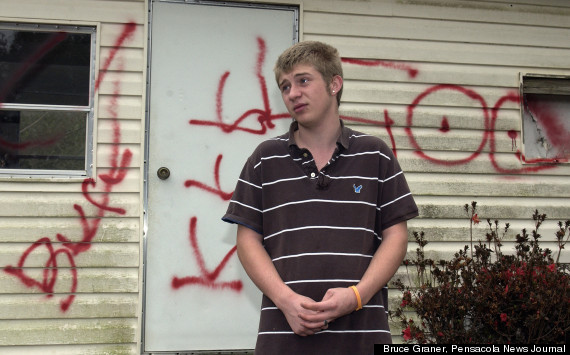 Jesse Jeffers, gay teenager, outside his vandalized trailer home.
